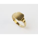 A 9ct gold signet ring, with a central canted square cartouche, set to stepped shoulders and plain