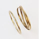 A 9ct gold slave bangle, the yellow gold twisted design bangle measuring 7.4cm diameter, together