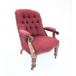 A mid 19th century button back mahogany frame open armchair, the arched padded back above mahogany