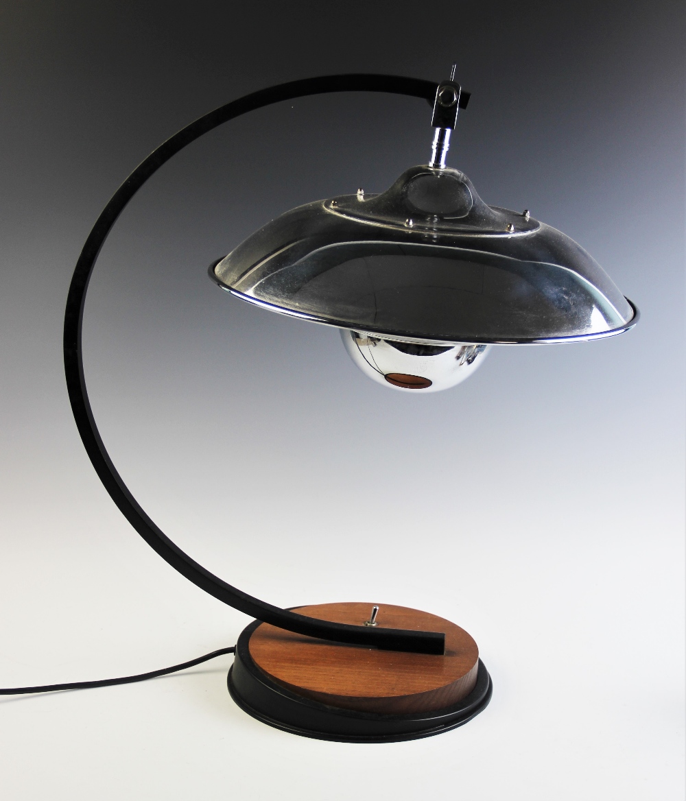 An Art Deco style table lamp, late 20th century, the bowl shaped chromed shade supported on a 'C'