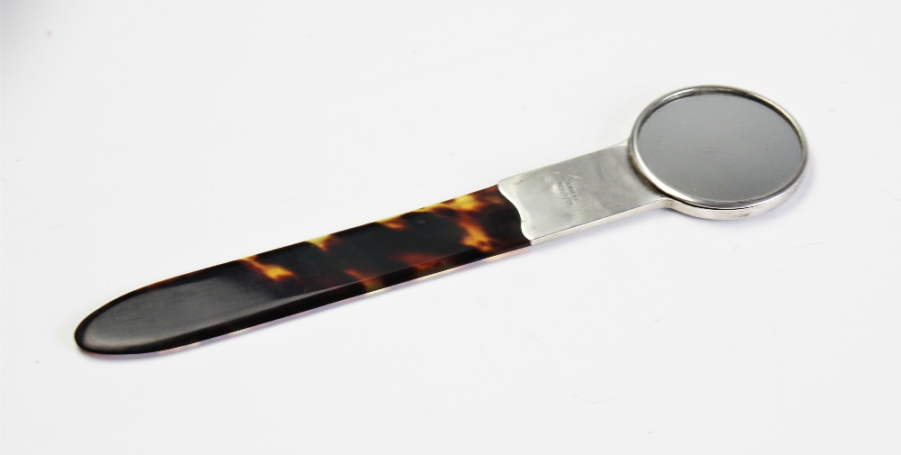 An Edwardian silver mounted tortoiseshell combination hand mirror and page turner, Goldsmiths &
