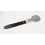 An Edwardian silver mounted tortoiseshell combination hand mirror and page turner, Goldsmiths &