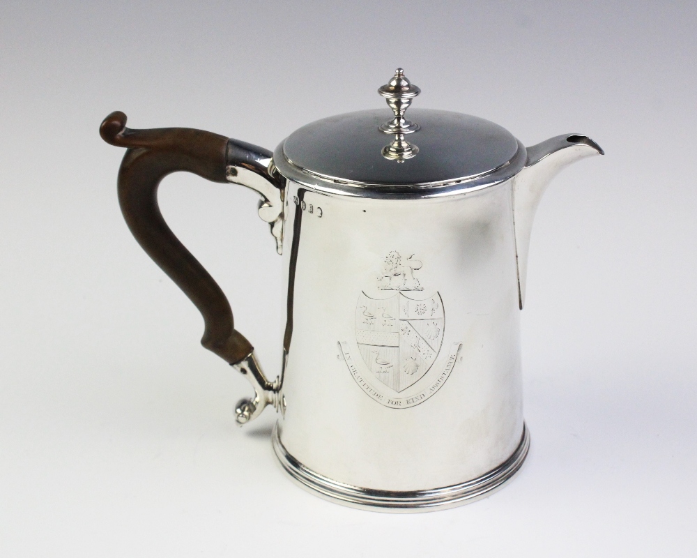 A George III silver hot water jug, London 1790, of tapered cylindrical form with scrolling wood