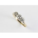 A diamond three stone ring, the central round brilliant cut diamond weighing approx. 0.25 carats,