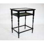 An Edwardian ebonised bijouterie table, the rectangular hinged cabinet raised upon slender turned