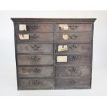 An 18th century oak estate chest, with two rows of six small drawers, applied with brass swan neck