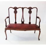 An early 20th century Chippendale revival twin seat mahogany chair, with two carved shell crests