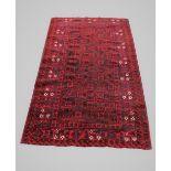 A Persian tribal rug, with traditional bokhara design against a red and blue ground, 184cm x 104cm