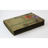 An Edwardian album, the cover decorated with floral and architectural motifs, containing a