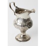 A Georgian silver cream jug by Hester Bateman, London 1780, of baluster form on circular domed foot,