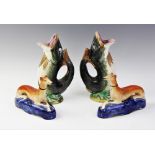 A pair of Staffordshire pottery ink wells, 19th century, modelled as a recumbent greyhounds, each