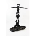 A Victorian style cast iron stick stand, stamped C G F, with 'C' scroll framed twin compartments