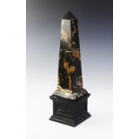 A large marble obelisk, the plain polished black obelisk of tapered form with russet and gold