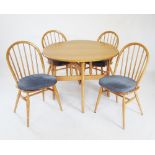An Ercol light elm 'Golden dawn' windsor drop leaf kitchen table and chairs, the oval drop leaf
