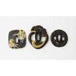 Three Japanese bronze Tsuba, comprising; a parcel gilt example, designed as a coiled snake,