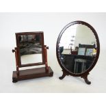 An early 20th century mahogany easel dressing table mirror, the oval mirrored plate within a