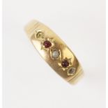 An early 20th century ruby and pearl set ring, comprising a small seed pearl with a small mixed