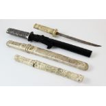 A Japanese tanto, with bone Tsuga and Tsuba, carved with figures, blade (Sori) 14.5cm long, with