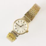 A lady's vintage Longines 9ct gold wristwatch, the circular white enamel dial with baton markers,