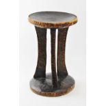 An early 20th century Southern African Shona stool, the dished seat raised on three swept