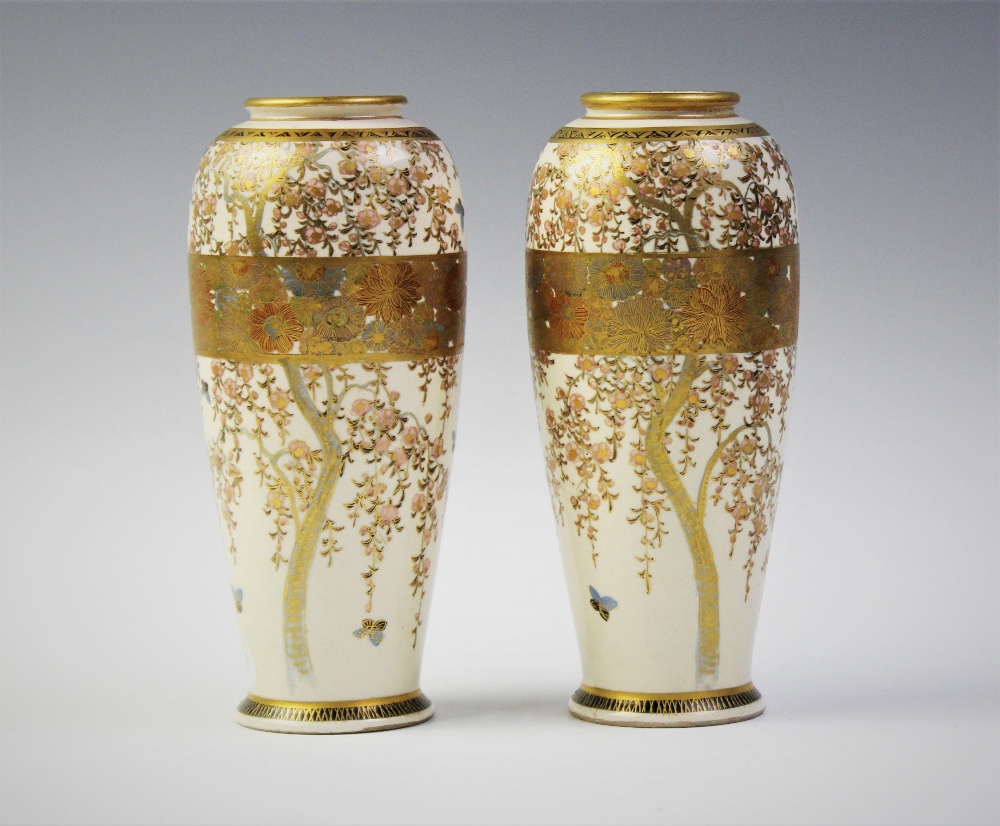 A pair of Japanese Satusuma vases, signed Seizan, each cylindrical vase extensively decorated with