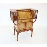 An early 20th century mahogany Arts and Crafts students desk, the angular 'C' shaped top enclosing a