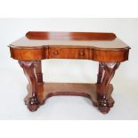 A Victorian mahogany dressing table, the invert shaped moulded top above a single frieze drawer,