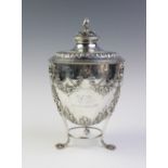 A late Victorian silver caddy by Martin, Hall & Co, Sheffield 1893, the urn shaped body resting on