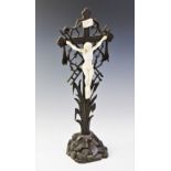 A carved Black Forest crucifix, early 20th century, Christ modelled in plaster of Paris and designed
