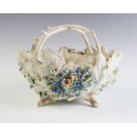 An Austrian porcelain centre bowl, late 19th century, the florally encrusted basket with bark