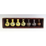 A cased set of seven Japanese cloisonne vases, Meiji Period, illustrating the process of cloisonne