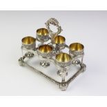 A George III silver egg cruet by Phillip Rundell, London 1819, the rectangular stand with