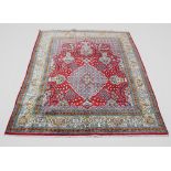 An old Perisan kashmar carpet, with bespoke medallion design and animal motifs in a red, blue and