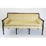 An Adams style mahogany framed sofa, early 20th century, the reeded top rail centred with a stylised