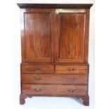 A George III mahogany linen press, with a dentil cornice above a pair of panelled doors enclosing