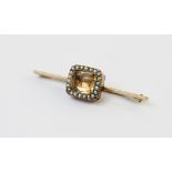 An early 20th century imperial topaz and seed pearl bar brooch, converted from an earlier necklace/