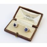 A pair of Edwardian sapphire and diamond cluster earrings, each comprising a cushion cut untreated