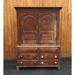 An 18th century oak livery cupboard, the two fielded panelled cupboard doors enclosing a vacant