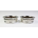 A pair of George IV silver bottle coasters, London 1826, each of circular form with fluted sides and