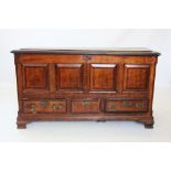 A George III oak and mahogany cross banded Lancashire mule chest, with four invert moulded panels