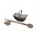 A 19th century boat shaped coal scuttle, with a fixed overhead handle, 46cm long, a 19th cast iron