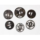 Six assorted tsuba, to include; a parcel gilt reticulated circular example depicting an