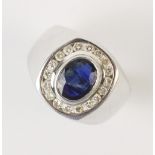 A sapphire and diamond cluster ring, comprising a central oval mixed cut sapphire measuring 9mm x