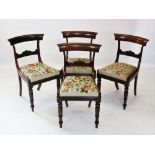 A set of six William IV rosewood dining chairs, each with a plain concave top rail above a scroll