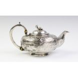 A Victorian silver teapot with marks for Henry Holland, of squashed ovoid form with scroll capped