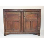 A late 17th/early 18th century oak hall cupboard, the rectangular moulded three plank top above a