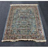 A duck egg blue ground kashmir rug, with tree of life design, 170cm x 120cm