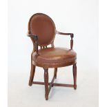 A Biedermeier style mahogany elbow chair, early 20th century, with an oval leather upholstered