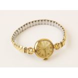 A lady's 9ct gold Smith's Deluxe vintage wristwatch, the round cream dial with Arabic numerals and