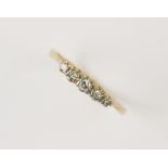 An early 20th century five stone diamond ring, comprising five round old cut diamonds of